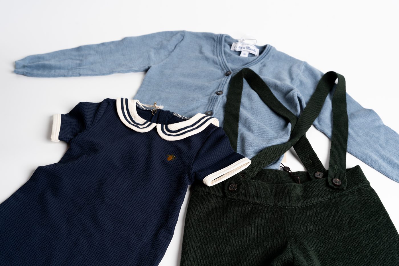 Filiz organic baby clothes neatly arranged — cardigan and corduroy overalls
